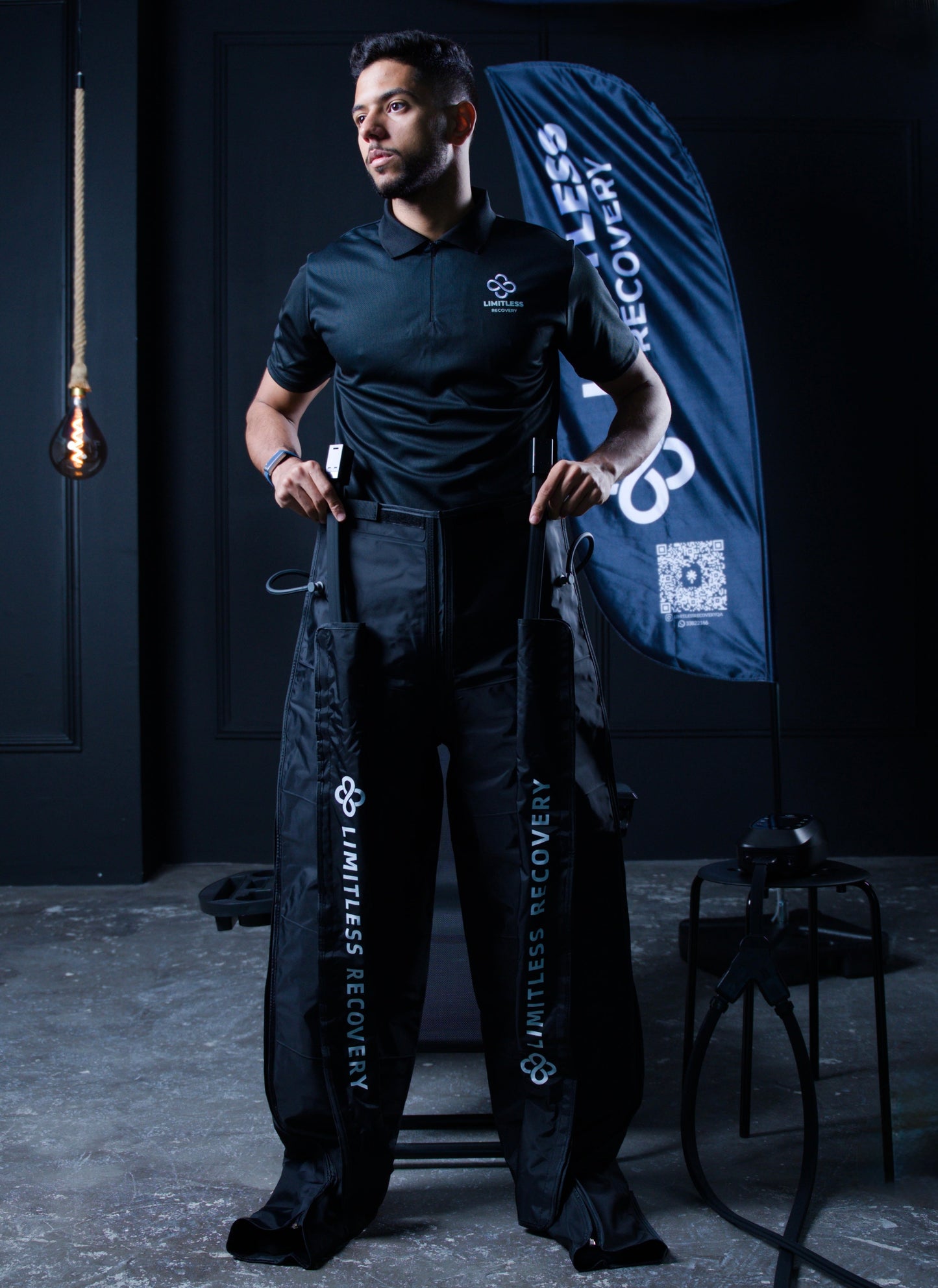 Limitless recovery shirt worn  by a man showing the pantslike  attachments of the recovery device 